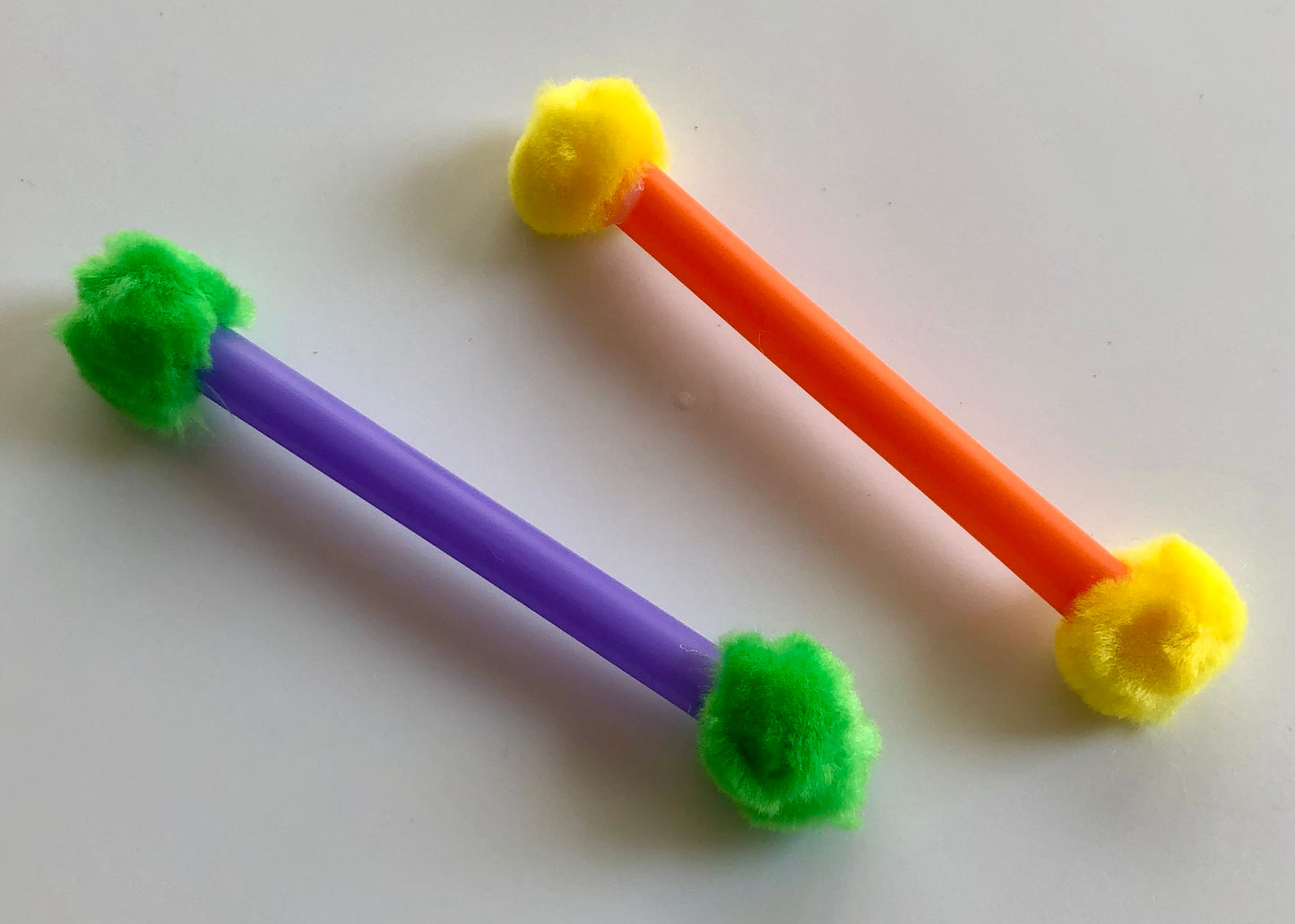 cat toys colourful lightweight, cats playfully bat and carry around, 5" long, closeup of toys, looks like a solid colour straw with different colour pompoms on each end