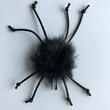 vegan faux fur "spider" cat toy, black body made with faux fur and "legs" made of black satin cord - body about 1" and legs 2.25"