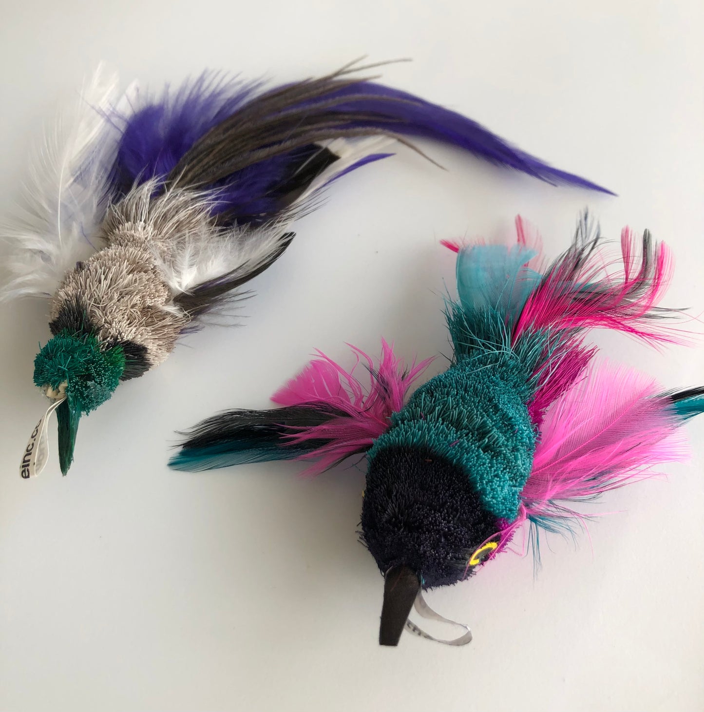 closeup of different versions of bird cat toy with different colours and feathers