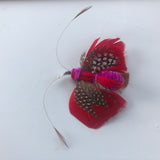 cat toy made with feathers that looks like a butterfly