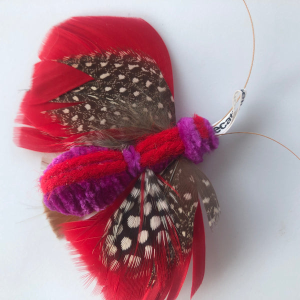 cat toy made with feathers that looks like a butterfly closeup