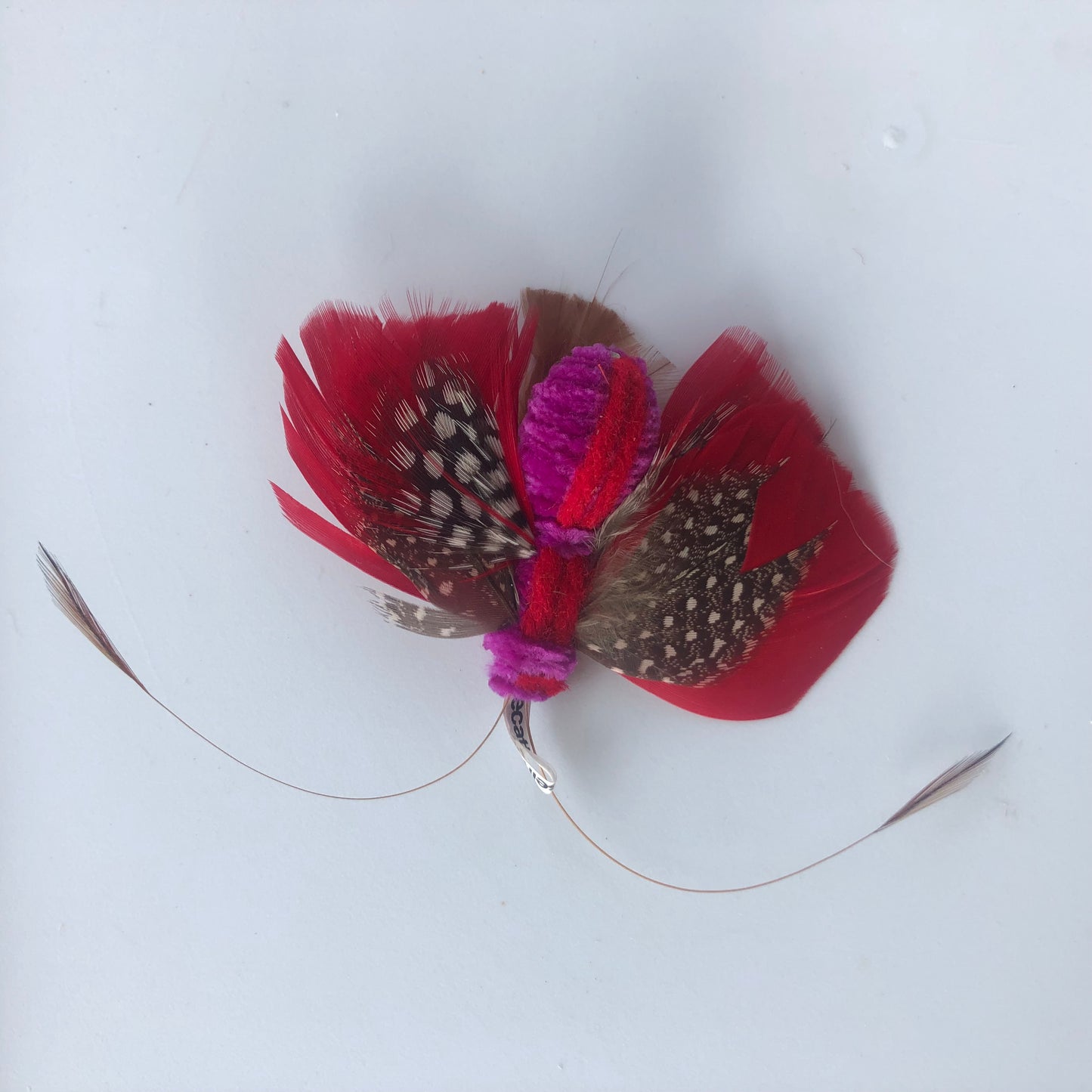 cat toy made with feathers that looks like a butterfly