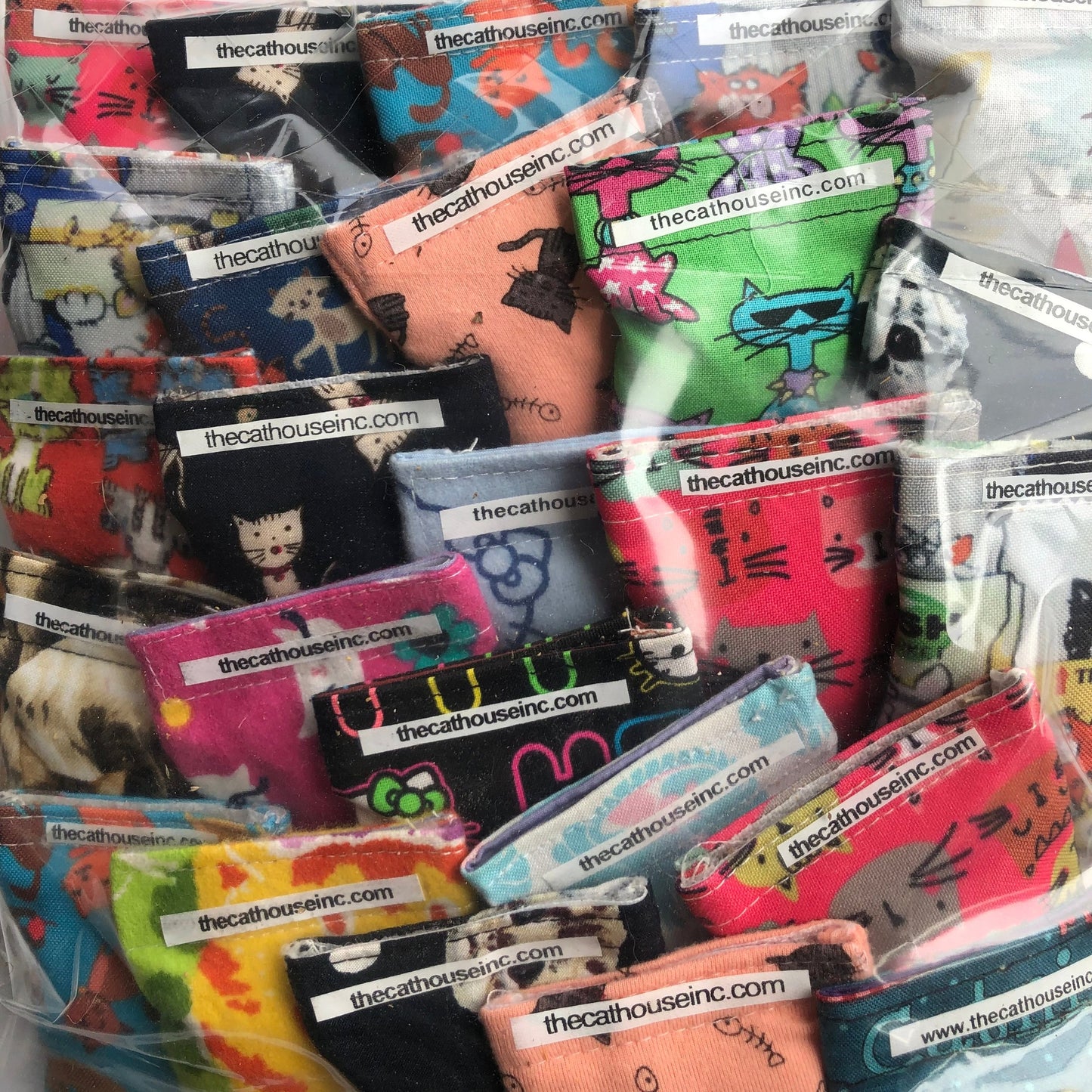 closeup showing variety of cotton refillable pouches that contain catnip + honeysuckle blend