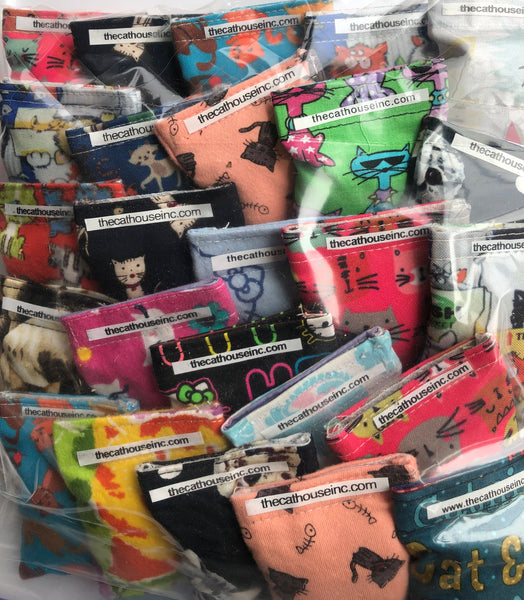 closeup showing variety of cotton refillable pouches that contain catnip + honeysuckle blend