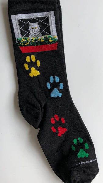 bestseller black crew sock with cat in window at top and 4 coloured paw prints from the ankle to toe