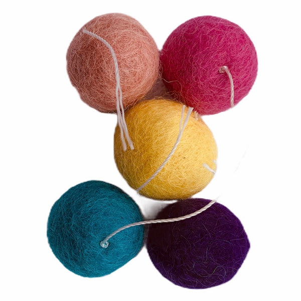 wool balls with thread "tail" are small enough for a cat to pick up with their mouth to carry or toss, just over an inch (2.5 cm) in diameter