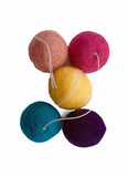 wool balls with thread "tail" are small enough for a cat to pick up with their mouth to carry or toss, just over an inch (2.5 cm) in diameter