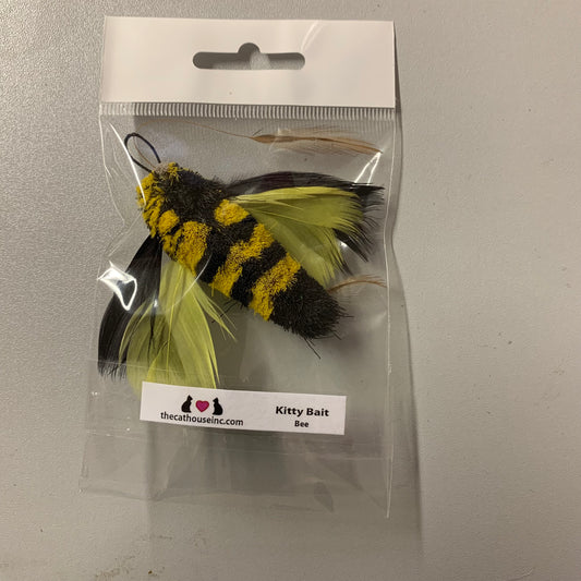 handmade cat toy attachment with black and yellow striped body and black and yellow feather wings