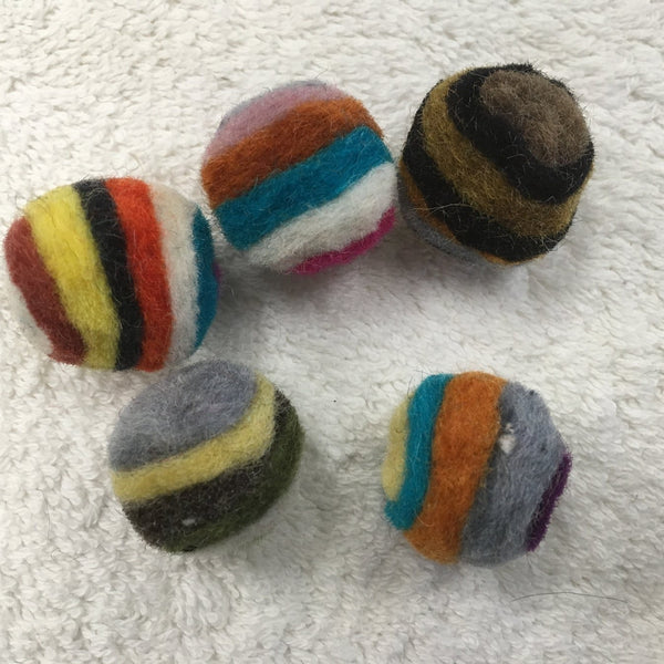 layered wool balls are small enough for a cat to pick up with their mouth to carry or toss, just over an inch (2.5 cm) in diameter 